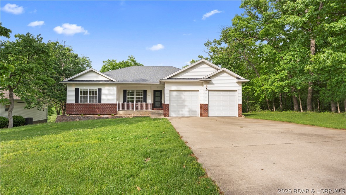 Experience the ultimate Lake Ozark lifestyle, perfectly situated on a quiet no-through street just steps away from a community playground and dog park. This meticulously maintained home is flooded with abundant natural light & shines with new interior paint, plush carpet and custom shutters. The home features newer stainless appliances & new dimmer switches throughout to create the perfect ambiance. Hobbyists will love the garage workbench & electric vehicle charger already in place. Nearly 2,500 sq. ft. of updated living space includes a finished walk-out lower level complete with a private bedroom & full bath—perfect for guests. The home is framed by fresh landscaping and features a deck overlooking a peaceful, wooded backyard with a firepit for cool lake evenings. As part of Four Seasons POA, enjoy world-class amenities: multiple outdoor pools, an indoor pool, newly remodeled 24-hour fitness center and a community center. Residents also enjoy access to pickleball courts, miles of walking paths, and private boat ramps. Anglers will love the four private internal fishing lakes. Minutes from golf & dining, this home offers resort-style living as a full-time residence or retreat.