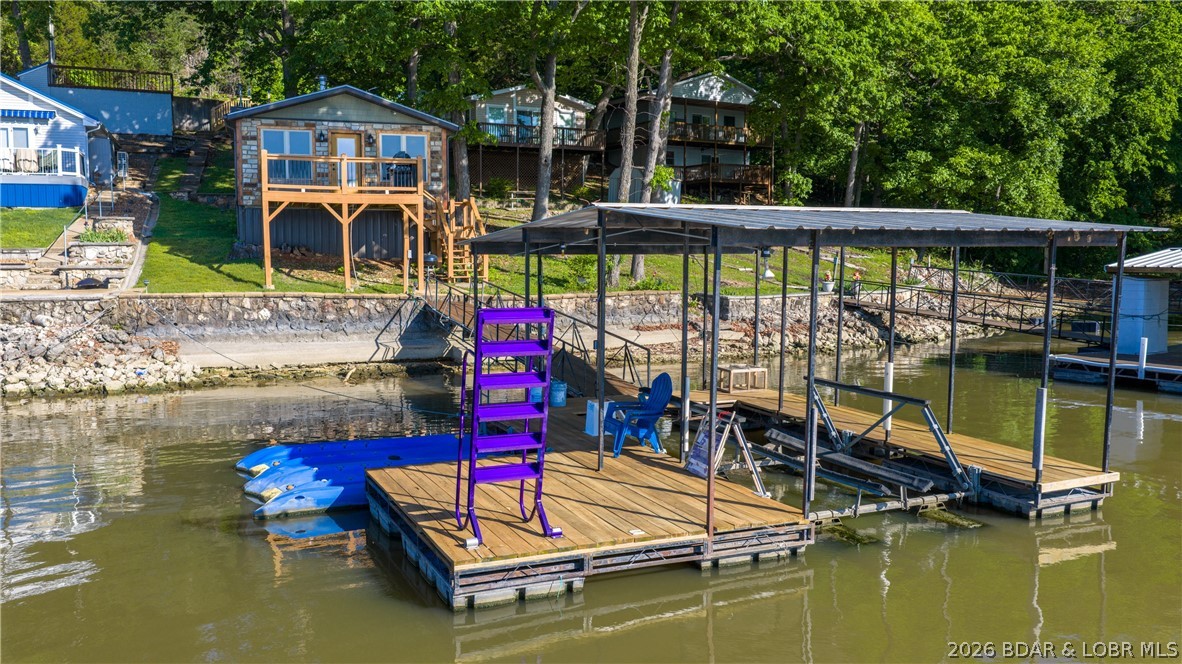 Big lake views and true cabin charm highlight this 1 bedroom, 1 bathroom lakefront retreat on the 2 mile marker of the Big Niangua arm. Offering roughly 600 square feet, this fully remodeled cabin was taken down to the studs within the last 10 years and features updated finishes throughout, including hickory kitchen cabinetry and efficient mini-split systems for heating and cooling. Co-Mo internet is available, and the home is being offered fully furnished and turn-key, making it ready for immediate use or rental. Positioned in deep water, the property includes a 1 well dock with a 10x24 slip that includes the boat hoist and 2 PWC drive-on lifts, making it ideal for boating, swimming, and enjoying the lake lifestyle. The setting captures a massive main channel view while still providing easy access with paved roads all the way to the door. Conveniently located by water near The Cave Bar & Grill, Nautifish, and Pier 31, and by land close to The Branding Iron, this property offers both accessibility and a true lake atmosphere. Nightly rentals are allowed, making this a great option for a personal getaway or an income-producing investment.