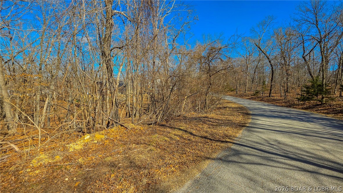 Discover the perfect canvas for your dream home in the prestigious community of Porto Cima. This premier 0.50-acre homesite offers a rare combination of secluded tranquility and commanding, year-round lake views. Ideally contoured to accommodate a custom walk-out lower level, the lot features 100 feet of road frontage and a gentle slope that leads directly to the community lake access area—seamlessly blending your backyard with the water’s edge. With water and sewer agreements already in place, you can move forward with your building plans with confidence and ease. As a resident of this highly sought-after enclave, you will enjoy the exclusive amenities of Porto Cima alongside full access to the extensive recreational offerings of the Four Seasons. The POA ensures a high standard of quality, requiring a minimum of 1,100 square feet to maintain the upscale character of the neighborhood. For those seeking even more privacy or a larger architectural footprint, the adjacent lot is also available for purchase, offering a rare opportunity to double your acreage and create a true lake-community estate.