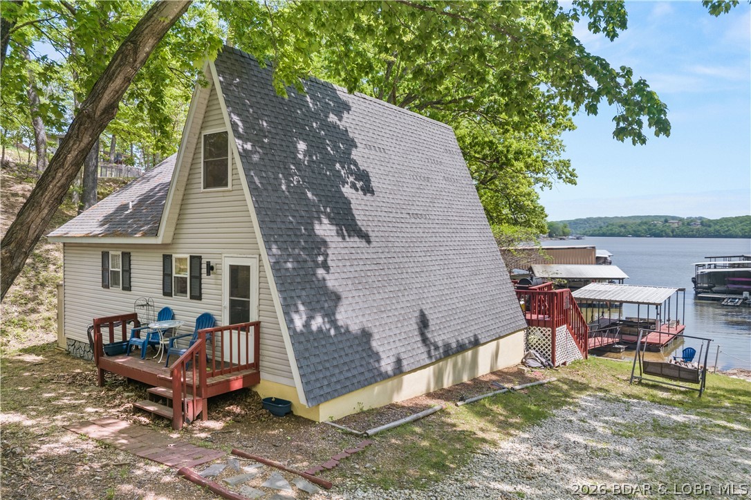 Escape to your private sanctuary in Sunrise Beach. Situated over half an acre at MM39, this cozy 2-bedroom, 1-bathroom A-frame is a lakefront treasure previously featured on HGTV’s Lakefront Empire. Perfectly positioned for both relaxation and profit, this home allows nightly rentals and comfortably sleeps eight, surrounded by mature trees and absolute tranquility. Inside, discover a bright, open-concept interior featuring tasteful furnishings, freshly painted walls, new flooring, and updated lighting throughout. Modern essentials include a smart thermostat, newer windows/doors, and custom cabinetry. The living space flows effortlessly to a spacious, restored deck—the ultimate vantage point for breathtaking lake views and outdoor gatherings. Enjoy 80 feet of private lakefront with an easy walk to your private one-well dock, newly equipped with updated electrical and integrated speakers. Located conveniently by land and water to premier dining and shopping, this property is truly move-in ready. Whether you are looking for a high-performing investment or a personal slice of paradise, this is the one. Experience the magic today via the fully interactive virtual tour!