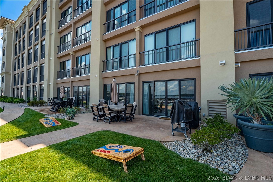 Enjoy lakefront living at its finest in this beautifully updated 3-bed, 3-bath walk-out unit in the exclusive Hamptons Condominium Complex at the 19 MM. Perfectly positioned for easy lake access, this unit features a private lakeside patio, lush green grass (dog friendly), breathtaking views, & direct access to the waterfront. You are just steps from the pool & your dock, which includes a 56' boat slip & dbl jet ski slip/hoist, complete w/2 SeaDoos included. Inside, the open-concept floor plan offers both comfort & entertaining. The spacious kitchen features granite countertops & Stainless appliances., incl. a gas range. Multiple gathering spaces & a game area offer plenty of room for family and friends to relax & enjoy. This condo is being offered fully furnished, w tasteful décor throughout. The complex offers a covered grilling area w seating, a fitness room, & clubhouse. Plus, Dog Days Bar & Grill is w/i walking distance, offering convenient dining, drinks, & entertainment. Whether you're looking for a full-time residence or a weekend retreat, this resort-style property offers location, amenities, & lakefront lifestyle. Don't miss the opportunity to own this desirable unit.