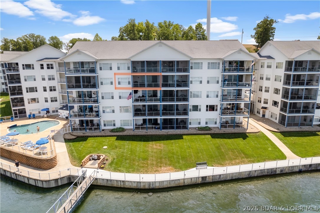 SENSATIONAL! One word describes this TRULY AWESOME unit's UNPARALLELED VIEW and Complex Amenities! This UPDATED Unit has Beautiful Cabinetry, LVP and Plenty of Storage! A Large Deck is yours to enjoy the amazing view! Located at the beginning of the Beautiful Gravois Arm at Lake of the Ozarks, nestled in a quiet, deeper cove area that has easy access to restaurants, gas docks and the main channel. 2 swimming pools (1 fresh, 1 saltwater) 2 dedicated swim platforms (1 with kayak launch), an exercise facility, fenced playground (with basketball & pickleball courts), and some of the best fishing at the lake will surely keep your family and guests entertained! Unit includes a 12 x 32 slip in a well lit and maintained dock equipped with features such as water, electric, security cameras and fish cleaning stations. This complex is meticulously manicured and pet friendly! The boardwalk is great for evening strolls and enjoying the lake views! Friendly neighbors and events are just some of the reasons that make Blue Anchor Bay one of the most sought after condominium destinations at Wonderful Lake of the Ozarks! Located within Minutes of Fabulous Restaurants & Entertainment by Boat!
