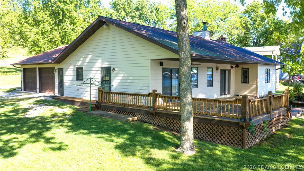 Do you need 1 level living on a nearly level lot? Price just improved!  Spacious living area with lakeview, open concept living dining & kitchen. Primary bedroom with lake view, walk in closet, and large bath. 2 additional guest bedrooms and full bath. Just off the kitchen is a large oversized 2 stall garage which is finished. There is a small office rm in the garage with utility rm.  Garage has a maintenance style deep sink, and you'll also find an additional stove for those busy holiday gatherings. This garage could easily transform into a recreation space when needed.  There is a sizable deck on the lakeside, just a couple steps up from the nearly level yard leading to the dock. There are sunscreens in the boat slip, which includes a boat lift. The boat in the slip will be included and is a 23 ft 87 Larson open bow. There is an open yard area next to this property, giving some privacy.  Across the street is an additional lot which is included.  Sellers are selling this home turn key, and this is an As Is sale, home furnishings, appliances and boat! Literally, you can bring your clothes and start your lake life!