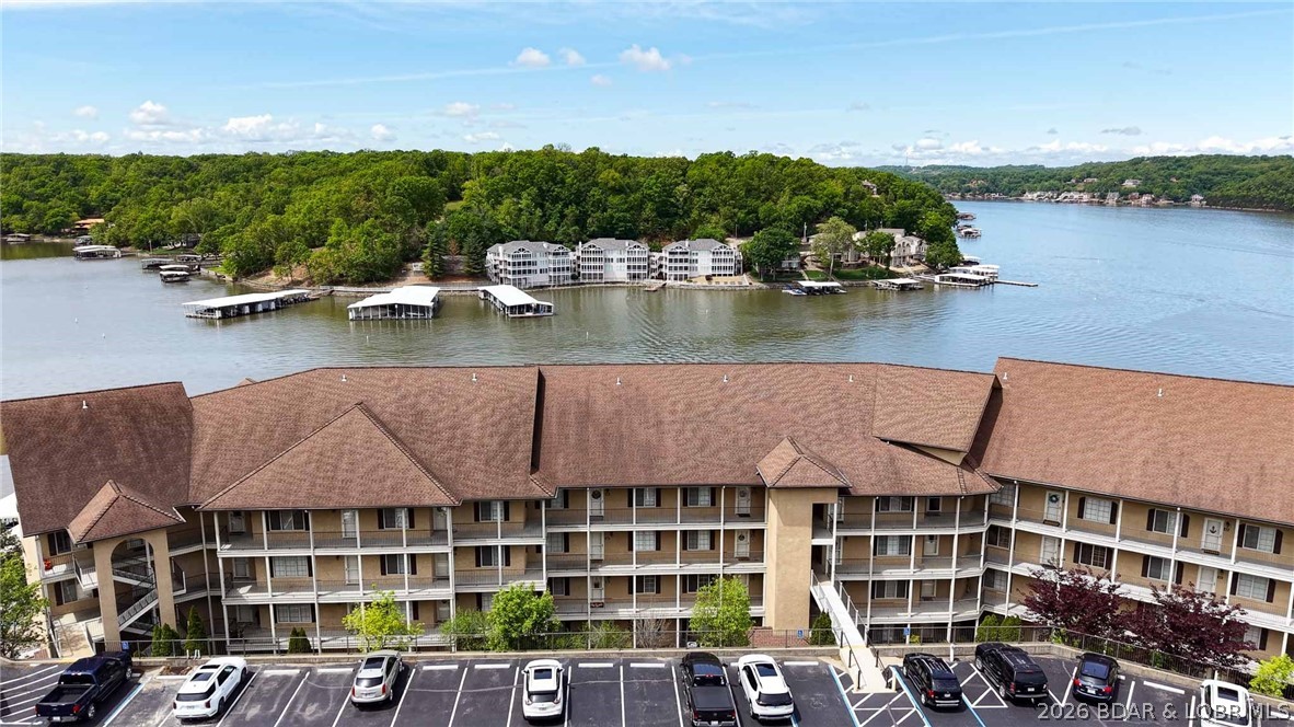 Experience effortless lake living in this 3-bedroom, 2-bath condo located in the highly sought-after Tuscany Condominiums at the 1 Mile Marker of the Big Niangua Arm. Skip the stairs—take the elevator just one level down for easy access, making this unit ideal for full-time living, weekend getaways, or investment potential. Inside, you’ll find a well-maintained, move-in-ready space with all appliances included, even a full-size washer and dryer. The unit is offered unfurnished, giving you a blank slate to design your perfect lake retreat. Step outside to a standout feature: a large 315 sq ft screened-in deck with tile flooring, perfect for relaxing, entertaining, or enjoying the lake air without the bugs. Boaters will appreciate the included 12x32 boat slip located in a deep water cove, offering reliable water access and protection year-round. Tuscany Condominiums offers resort-style amenities, including a clubhouse, community pool, and well-maintained grounds, delivering the ideal balance of relaxation and recreation at the Lake.
If you’re looking for low-maintenance lake living with strong usability and boating access, this one checks the boxes.