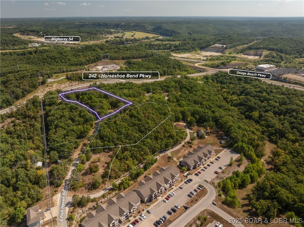 Prime time location with this approximately 3 acre tract of ground in the center of Lake Ozark.  Great visibility, easy access off of Fish Haven Road and water and sewer close so extension of infrastructure is readily available.  Property is zoned residential but in an area primed for commercial development moving forward.  Some of the ground is gentle off of Fish Haven Rd and it drops off as you approach Hwy 242.  Great visibility from Hwy 242 which appears to be the future of Lake Ozark. Only minutes from The Bagnell Dam Strip, Menards, Kohls, the movie theater and everything else yet to be built on Hwy 242. Lot is within the City of Lake Ozarks Tif district. With this visibility and the TIF viability this property is a great development piece.