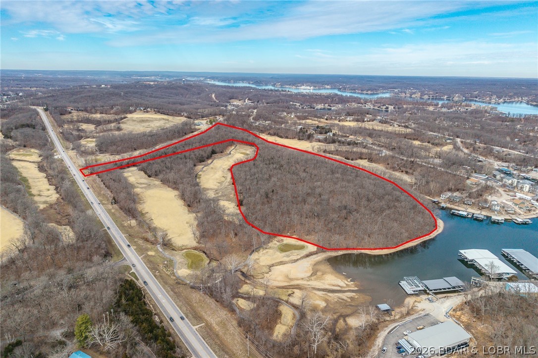 Exceptional 32± acre development opportunity located along highly desirable Horseshoe Bend Parkway in the heart of the Lake area. This expansive tract offers a rare combination of size, accessibility, and proximity to established residential and recreational amenities-making it ideally suited for a wide range of development possibilities.
Positioned near the entrance corridor to Horseshoe Bend, the property benefits from strong visibility and convenient access, while being surrounded by established communities, golf course frontage, and near by lake access points. the natural topography features a blend of gently rolling terrain and elevated ridge lines, offering the potential for scenic views and creative site planning. 
Utilities are nearby (buyer to verify), and the property's configuration lends itself well to residential development, including villas, townhomes, single family clusters, or a mixed-use concept. The surrounding area continues to experience steady growth, with increasing demand for both full-time residences and second-home investment properties. 
With limited large-acreage parcels remaining in this immediate area, this presents a unique opportunity.