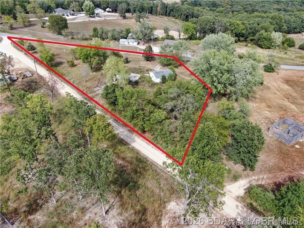 Enjoy the peaceful setting and convenience of a lot that’s ready for your vision! Discover the perfect opportunity to build your dream home on this spacious 1-acre lot. The property already includes an existing basement foundation, a spacious 2-car garage, private well, electric hookup, and a lagoon—saving you time and money as you plan your build. So much of the essential groundwork has already been completed. Located just 15 minutes from Osage Beach, this would be a great property for someone looking to move to the country while still having a short commute.
Note: This listing is for the lot and existing improvements only. The house shown in the photo is a virtually generated rendering to illustrate potential and is not included in the purchase price.