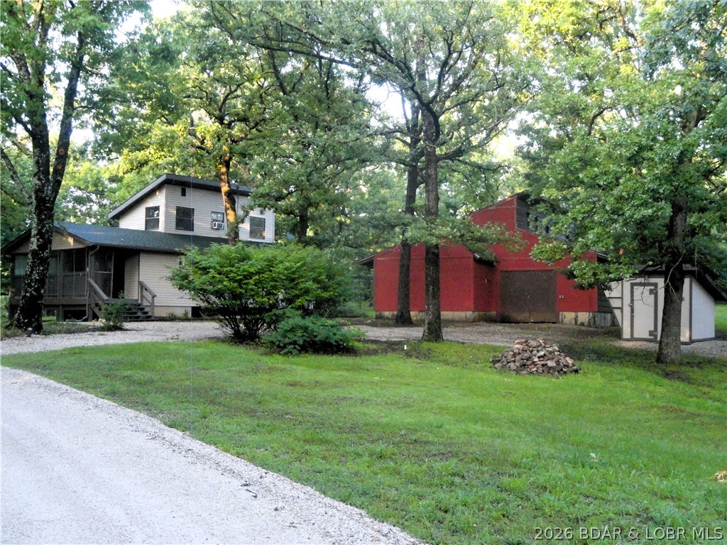 Peace, privacy, and utility are yours at this cozy home located just minutes from beautiful Ha Ha Tonka State Park. This wooded acreage features a large powered barn, offering the perfect setup for a contractor workshop, hobby farm, or secure private storage for your boats, jet skis, and RVs away from high lakefront costs. This home is a  charming 1,042 sq. ft. layout features a spacious main bedroom and a bright loft— perfect for a second bedroom or home office. Includes a dedicated utility room with washer/dryer hookups and upright freezer space. The Land & Barn: 3.3 unrestricted acres gives you freedom to expand. A large barn also features an integrated, insulated chicken coop ready for your homesteading dreams. Turnkey Infrastructure: Rural peace of mind is built right in with a new, warrantied well pump and 32-gallon tank on a deep well. Appliances Included: Move right in! The refrigerator, gas stove, and microwave are included. Enjoy the peace of the countryside with quick access to the best amenities of the Lake of the Ozarks. Schedule your tour today!