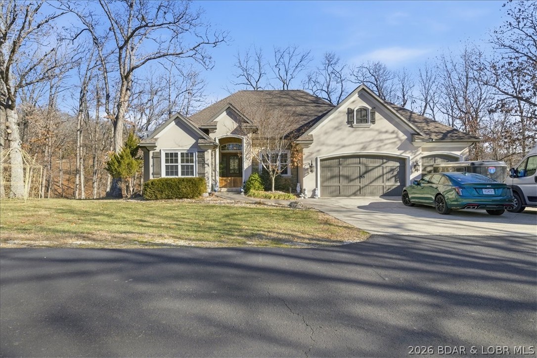 Spacious Updated Home on a 1.75 Acre Lot in Prime Location! This well-built and beautifully maintained 6-bedroom 4.5-bath home is ideally located just minutes from Osage Beach and Camdenton. The main level features an open-concept kitchen and living area highlighted by an electric fireplace, creating a warm and inviting space for everyday living and entertaining. Also on the main level are a private master en-suite, two guest bedrooms, an additional full bath, a dedicated dining room, and a convenient laundry area. Step outside to enjoy the concrete deck, perfect for relaxing or hosting guests. The lower level offers exceptional flexibility with a second master en-suite, two additional bedrooms connected by a Jack-and-Jill bathroom, a half bath, a second living area and another washer/dryer hookup - ideal for guest or multi-generational living. A composite deck extends the living space outdoors, and a built-in safe room adds peace of mind. A rare opportunity to own a spacious, move-in-ready home in a highly desirable location.