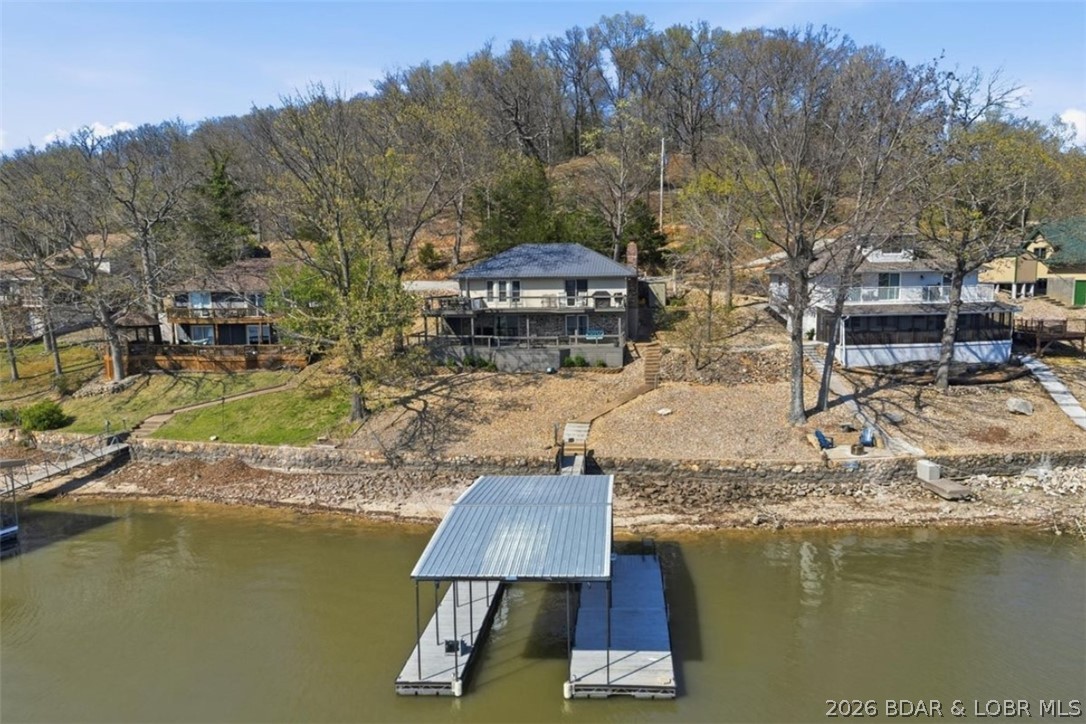 Outstanding views, multiple hangout spaces, and a setup built for lake living—this 4 bed, 2 bath home at the 48 MM brings the full package and is selling almost totally furnished! The main level features an open kitchen, dining, and living area that flows right out to the deck, making it easy to entertain or just take in the stunning views. Downstairs, a second living space with an office area and high-top table gives everyone room to spread out—perfect for hosting a crowd or longer stays. The home has been nicely updated throughout with a fresh, inviting feel while still keeping that relaxed lake vibe. Outside is where this one really shines with multiple deck spaces designed for gathering, grilling, and soaking in the view. The dock includes a 10x30 slip, swim platform, and fish cleaning station—this area is known for excellent fishing and great for water sports with calmer waters here! Not a lot at this home hasn't already been updated. From paint, fixtures, and flooring to a brand new septic system this year and roof replacement a few years back. If you’re after a true lake place with big views and room for everyone—this is it! NO hoa, fiber internet, and pavement to the door!
