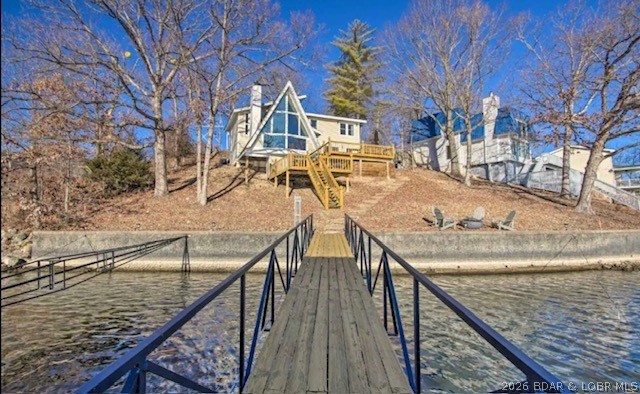 Back on the market with updates.

Stunning A-Frame Lakefront Retreat located at the 1 MM in Lake Ozark. This beautifully updated home offers the perfect blend of modern design, comfort, and breathtaking lake views. Nestled right off the 1 MM in a protected cove with main channel views, this home is ideal as a vacation getaway or a profitable nightly rental investment. The home was recently listed under a new management firm that has the place booking up solid due to the unique home features and location. 
Featuring three spacious bedrooms and 2.5 bathrooms this home boasts over 2000 sq ft of stylish living space. Every detail has been thoughtfully designed - from the open-concept living area filled with natural light to the sleek finishes throughout.
Step outside to your expansive lakeside entertainment area, perfect for hosting family and friends. Enjoy cozy evenings by the fire pit, soak in panoramic lake views, or head down to your private dock for all your lake desires.
When you enter the property you will love the tall ceilings, exceptional views of the main channel, cove protection, and an outside patio area that makes for the ultimate lake gathering.