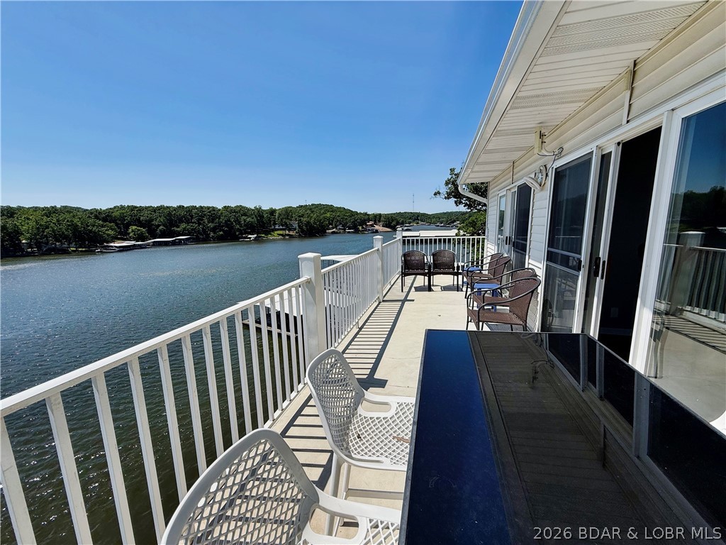 Lake life just got a serious glow-up! This beautifully remodeled top floor 4-bedroom, 3-bath lakefront end unit condo with a community pool blends modern style, comfort, and investment potential. Completely updated in 2023, it features luxury flooring, fresh paint, and an updated kitchen with stainless steel appliances, including a newer refrigerator. Sold furnished (see inventory list), including a newer washer and dryer, it's truly move-in or rental ready. The floor plan offers two ensuite bedrooms, one on the main floor and the other upstairs, plus a loft that serves as a second living area, providing plenty of space and privacy for family and guests. Relax on the spacious lakefront deck overlooking the 11 MM with stunning main channel views, while enjoying the protection of a deep-water cove. A 12x30 boat slip is included for easy days on the water. Owners and guests will love the lakeside community pool, and the lower HOA dues and smaller sized complex make ownership even more attractive. Minutes from shopping, dining, golf, and entertainment, this condo is the perfect full-time home, weekend getaway, or income-producing vacation rental. Schedule your showing today!
