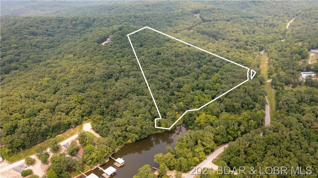 Great laying 9.8 acres located at the 45mm. Property does include back of the cove lake frontage. Gated entrance (shared with neighbor), creek running along the front side of property. Acreage lays really well and has already had a septic perk test done and has been surveyed. excellent spot to build that private retreat! Property is under contract with a 72 hr kickout.