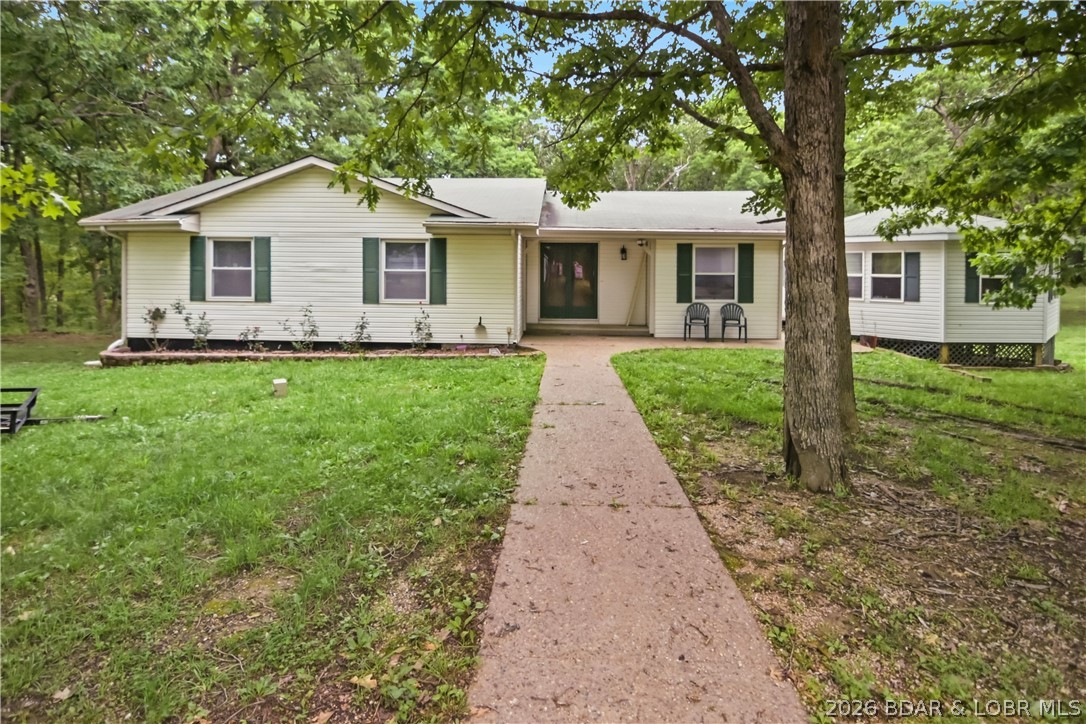 Tucked away on nearly 6 acres just minutes from Eldon, this spacious country property offers the privacy & elbow room you’ve been looking for. Easy highway access makes getting to town simple, while the setting provides the peaceful feel of true country living. This 2-story home with walkout basement offers over-sized living spaces throughout, including 4 bedrooms, 3 bathrooms, 2 family/living areas, and a generous dining space perfect for gatherings. The gentle acreage around the home is easy to enjoy and provides plenty of room for hobbies, pets, & outdoor activities. One of the standout features is the incredible garage/workshop setup featuring a 3-car garage with work area & bathroom, plus an additional detached 1 car garage. Connected by deck to the home is a unique octagon structure with a sunken hot tub that offers endless flexibility as an entertaining space, hobby room, or future customization project. Inside the home you’ll appreciate granite counters, newer flooring, generator backup, & several thoughtful upgrades throughout.  If you’ve been searching for a solid, spacious home with acreage, functionality, and value in a private country setting close to town, this is it.
