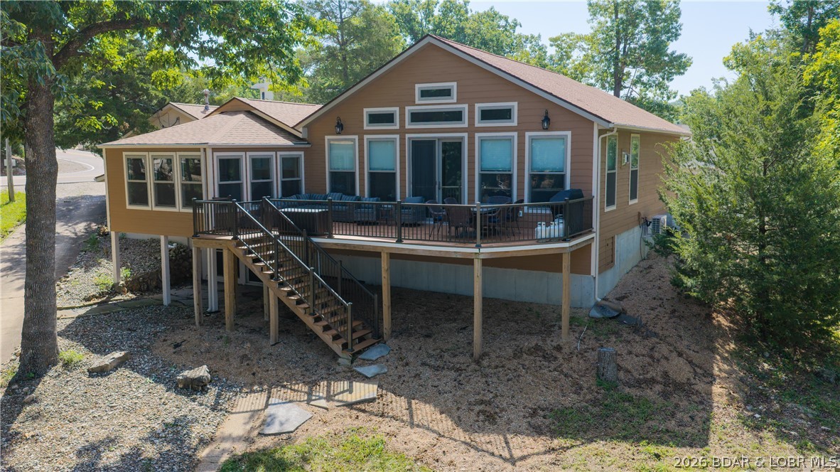 Welcome to lakefront living at its finest! Perfectly situated in a quiet cove at the 8 Mile Marker on the western end of Horseshoe Bend, this beautifully remodeled 4-bedroom, 3-bath home offers the best of both worlds with peaceful cove protection and stunning main channel views. Enjoy approximately 79.5 feet of shoreline with no steps to the water, a rare private HOA boat ramp, and a covered dock featuring two boat slips, a large swim platform, and wet steps. Extensively updated in 2018 and again in 2022, the home features Amish custom cabinetry, a spacious open living area with a gas fireplace, and a walk-out lower level providing easy lake access. The finished 450-square-foot lakeside boathouse with HVAC, half bath, and refrigerator creates the ultimate entertaining space. Additional highlights include a three-car garage, parking for approximately eight vehicles, a reverse osmosis water system, newer HVAC components, and recent updates. This exceptional waterfront property offers privacy, convenience, and everything you need to enjoy the Lake lifestyle. Enjoy one of the Lake's most desirable locations, minutes from waterfront dining, shopping, and entertainment by land or water.