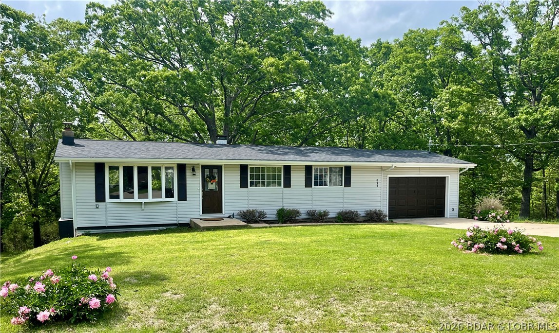 Newly updated home at the end of a dead end street, in the middle of Camdenton, that has two lots that total over an acre of ground PERFECT for a garden spot or a beautiful fire pit outside of your back door.  671 square feet unfinished in the basement leave lots of options.  All new floors throughout the home, featuring a brand new kitchen with quartz countertops with ample space for a large kitchen table, new roof, gutters and interior paint.  Vaulted ceilings give the open concept a big and airy feeling with windows that pour in so much natural light.  Three bedrooms and one bathroom upstairs, with a large family room and wet bar downstairs.  This home has beautiful views from your covered deck off of the kitchen, and from the covered patio off of the lower level.  HUGE lot that invites your parking of an RV, bass boat, or plenty of cars for the family when visiting.  The downstairs could easily be adapted into a separate apartment of living space with over 600 square feet to finish any way you like and an easy driveway to the back of the home.    The lower level is set for a bathroom with all plumbing ready for easy installation.
