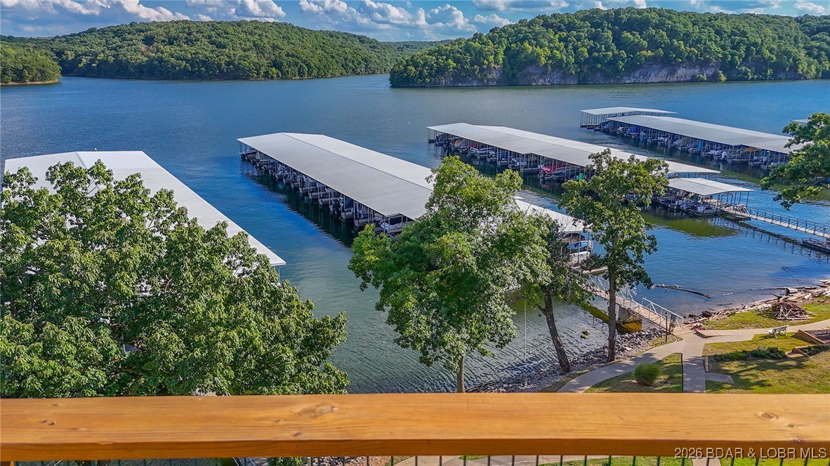 Four bedrooms and a boat slip on the water for 325K!!  Don't miss this one!   
Enjoy all the lake has to offer with this charming 4-bedroom, 3-bathroom top-floor, end unit condo!  Located just minutes from the Lake of the Ozarks State Park, this unit features breathtaking views and generous space for relaxing or entertaining.  The main floor includes an open concept living area, three spacious bedrooms, and two full bathrooms. The loft level offers a private fourth bedroom ensuite and a second living space, ideal for guests, a media/game room and more!  Interior updates include new living room flooring, a newer HVAC system, and fresh paint throughout. Offered completely TURNKEY, this condo is move in ready so you can start enjoying lake life right away!  Community amenities include a community dock, boat slip, outdoor pool, a workout room and plenty of green space!  Rentals are allowed, making this a great option for personal use, investment, or both.  For convenience, condo can be accessed by either a blacktop road (Whispering Oaks) or a gravel road.