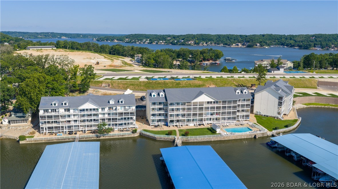 Rarely does a 2 bedroom condo at Westside Bay hit the market, so don't let this one slip away! Located on the quiet side of the lake in Sunrise Beach at the 11 MM, this WALK-IN level condo offers the convenience everyone wants with only 3 steps to the front door...because hauling coolers, groceries, and lake toys up endless stairs is overrated. This 2 bedroom, 2 bath retreat features spacious bedrooms, an oversized laundry/utility room for extra storage, and recent updates including a newer HVAC system and water heater (2022). Most furnishings are included, making it easy to start enjoying lake life immediately. Relax on the screened lakeside deck overlooking the peaceful cove, or head down to the heated lakefront pool. The package includes a 12x40 boat slip and 1 PWC space, so there's plenty of room for your lake toys. Westside Bay is a small, well-maintained community with green space, blacktop roads to the door, elevators and a prime location near popular waterfront restaurants. Move-in ready, easy access, great views, and a boat slip included...sounds like the lake condo trifecta!