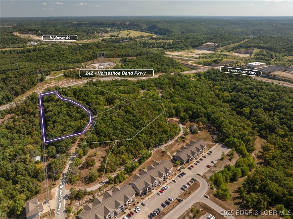 This nearly 2 acre lot is on a great blacktop road and has easy access.  Several homes should be able to be built here and Multifamily is possible with appropriate approval. Apartments and multifamily have proven successful in this area and with what is planned for Lake Ozark in the coming years this could be the perfect location. Gentle topography and water and sewer close!  There is more acreage that is also listed just a stones throw away.   Your chance to be a developer on several great properties!