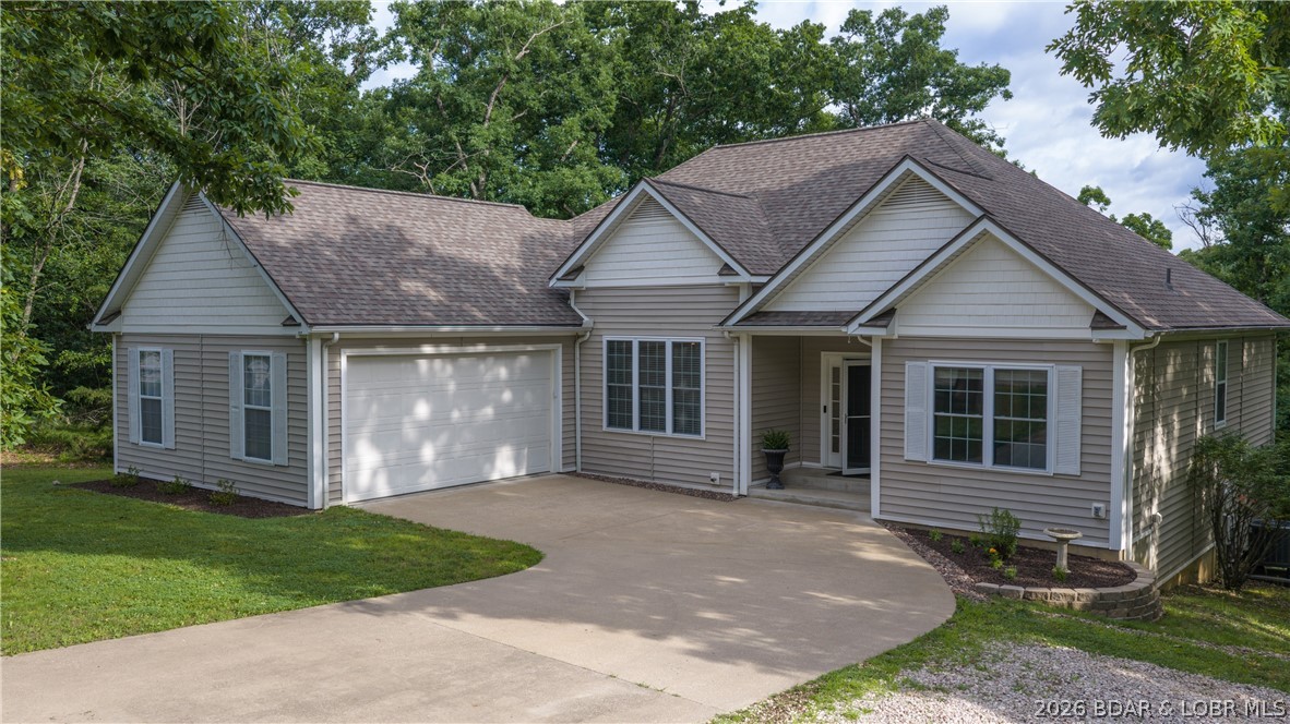 Highly sought-after home in Four Seasons community of Lake Ozark. This 3-bedroom, 2-bath home offers 1,850 square feet of comfortable one-level living space on a rare double lot, providing extra privacy and room to enjoy the outdoors. A flat driveway and 2-car garage make everyday living easy, while vaulted ceilings create an open, spacious feel throughout the main living area. Entertain family and friends in the inviting floor plan designed for both comfort and functionality. The kitchen flows seamlessly into the living and dining areas, creating a welcoming space for everyday living and special occasions. Located in the heart of Four Seasons, owners enjoy access to outstanding amenities including swimming pools, tennis and pickleball courts, parks, playgrounds, walking trails, campground, boat launch access and year-round community activities. Conveniently located near golf, dining, shopping, entertainment, and Lake of the Ozarks attractions, this property is ideal as a full-time residence or weekend retreat. Homes with a double lot, flat driveway, and access to Four Seasons amenities are hard to find, don't miss this opportunity to make 135 Clover Point your next home.