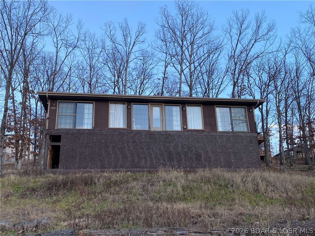 Unique opportunity for a Fixer Upper. Turn this home into your own Lake escape, full time residence, Air BnB, or just fix and flip.  Home is finished, and furnished, on the upper level, sitting on a new unfinished walk-out basement that can be finished to your specs. Currently a 4 bedroom 3 bath with 2 large master bedrooms with en suites. Full kitchen, dining area, and livingroom. All utilities are run to the home and just need hooked up. Hook-up the utilities and you could live in the home while doing your renovations. Home is being sold as-is.