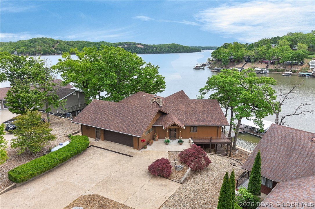 In Greenview Area @ 32½ Mile Marker on Osage Arm of Lake of the Ozarks—LOCATION-LOCATION! Meticulously Maintained 3,867 SqFt Lkfrt Home offers SO MUCH: A Wide Vista of Impressive Main Channel Views & of (no-wake) Standing Rock Hollow Cove. 104 Ft Shoreline w/ Lkfrt GAZEBO & Lkfrt Boardwalk. INSIDE: Walls-of-Lakefront-Windows to View & enjoy Mesmerizing Lake & 2 Well Dock from Din’g Rm, Kitch, 2 Levels of Liv’g Areas, ALL Bedrms & 2 Levels of Wrap-Around Covered Lkfrt Decks. Light-&-Bright Hm w/Abundance of Cheerful Natural Light'g. Pride of Ownership Evident upon Arrival into Coveted BOYD SUBDIVISION. 3 Bdrms (+Could Convert Office & Stg Area in Garg into 4th Bdrm), 2 1/2 Bath, Fireplace, Impressive Gorgeous FULLY REMODELED GOURMET KITCHEN (Will win Anyone Over), Granite, Custom Cabinets w/Lead Glass Panels, WOLF Stove, Dbl Ovens, Built-in Bakers Mixer Station. Pullout Panty Shelv’g, Eye-Level Dishwasher & more. Attached 2 Car Garg w/Extra Storage Area. Lovely Landscape, Lots of Prk’g. A Commt’y Park. A Marina & 2 Lakefront Venues in this Cove. Just Min’s to MANY Lkfrt Venues by Boat & 10-15 min Drive to Shop’g, Restaurants, Town & Schools. See EXTRA FEATURE SHEET