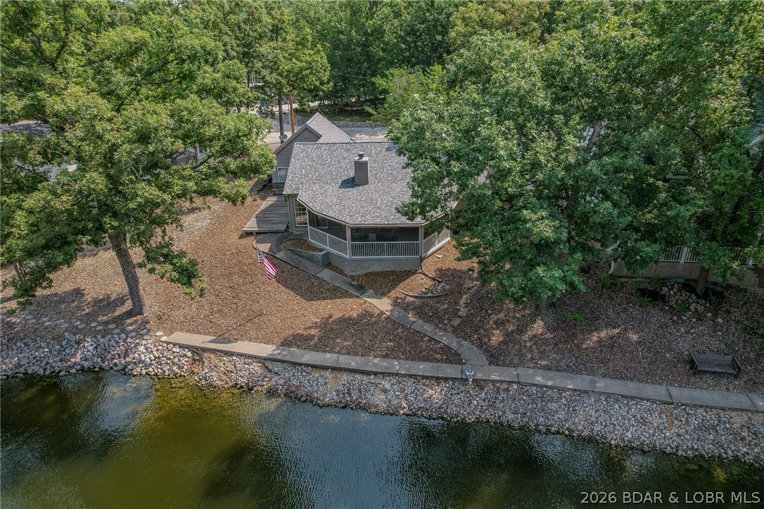 Don’t miss this beautiful 3 bedroom, 2 bath waterfront home ideally located just off Horseshoe Bend Parkway in a rental-friendly area.  Perfect as a full-time residence, weekend escape, or income-producing investment. Step inside to a bright, inviting open-concept layout designed for both comfort and ease of living. The living area is filled with natural light thanks to large windows that perfectly frame those stunning lake views. Being sold fully furnished, this home is truly turnkey, just bring your suitcase and start enjoying lake life. Outdoor living is where this property really stands out. The spacious screened-in deck is the perfect spot for morning coffee or evening relaxation, all while taking in the peaceful lake views. An additional open deck with built-in seating creates the ideal setting for entertaining family and friends. A gentle walkway leads you down to a waterfront path, offering scenic strolls right from your backyard. The home also features a 2 car garage with plenty of room for vehicles, lake toys, and extra storage. And to top it off, a 10x24 slip with hoist in the community dock is included, making it easy to get out and enjoy the water anytime.