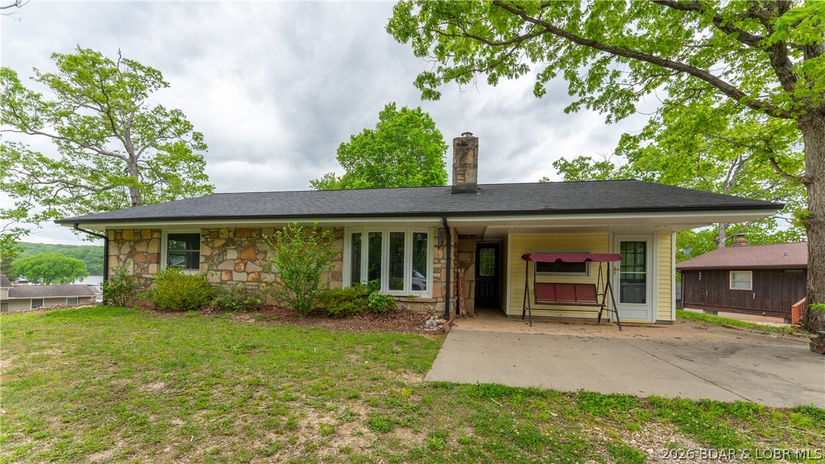 Charming 3-bedroom, 1 full bath, 2 half bath home located in a quiet Camdenton subdivision with beautiful views f Lake of the Ozarks! Built in the early 1900s, this home offers character and timeless charm that is hard to find. Recent updates include a new roof, gutters, fascia, and HVAC (3 yrs old), new water heater (1 yr old), new black stainless-steel appliances, and a brand new screened in porch. All one-level living makes this an ideal starter or retirement home. Additional rooms offer ample storage or potential for extra bedrooms or a home office. Don’t miss this rare blend of historic charm and modern convenience!
