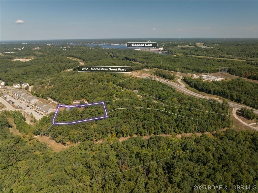 Apartments anyone? This nearly 2 acre lot is R-3 High-Density Residential and was originally intended for a 16 unit apartment building. Apartments and multifamily have proven successful in this area and with what is planned for Lake Ozark in the coming years this could be the perfect location. Gentle topography, water, sewer and great access via city roads. Home that is on the property has no value as this is being sold as a development site. What else could you ask for. More like this? There is more acreage that is also listed just a stones throw away. Your chance to build multiple buildings!