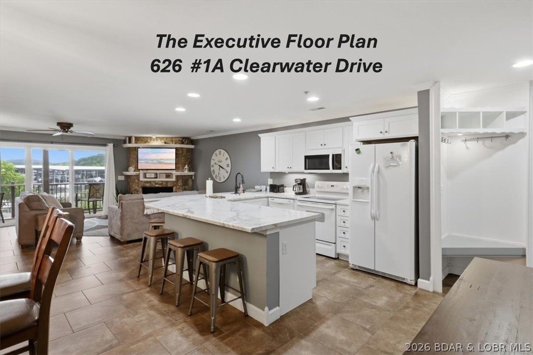 Wow, check out this ground floor, waterfront EXECUTIVE floor plan condo at Clearwater Condos in Camdenton @ Lake of the Ozarks. This rare Executive floor plan has approximately 1,426 sq ft of living space, which is perfect for a buyer wanting a bit more than the average unit. The Kitchen has spacious wrap around countertop space that accommodates add'l guest for seating or for the cook that likes the extra space. The unit has beautiful large tile flooring for easy cleaning. The Family room has a corner fireplace & a sliding glass door that leads to a nice covered deck, & views of the mail channel. French Double doors lead to the Owners Suite with a walk in closet, access to the deck, & a private full bath with double sinks. Bedroom #2 is spacious & has a King Size bed, & access to a 2nd full bathroom with linen closet, Bedroom #3 offers twin beds. Washer/Dryer included, The unit comes fully furnished so you can move right in! Included in this package is a boat slip on Dock F.  There are wave runner slips available to purchase from other owners in the complex. Whether your looking for a rental income producing condo, or a unit for your personal enjoyments, this one is sure to please