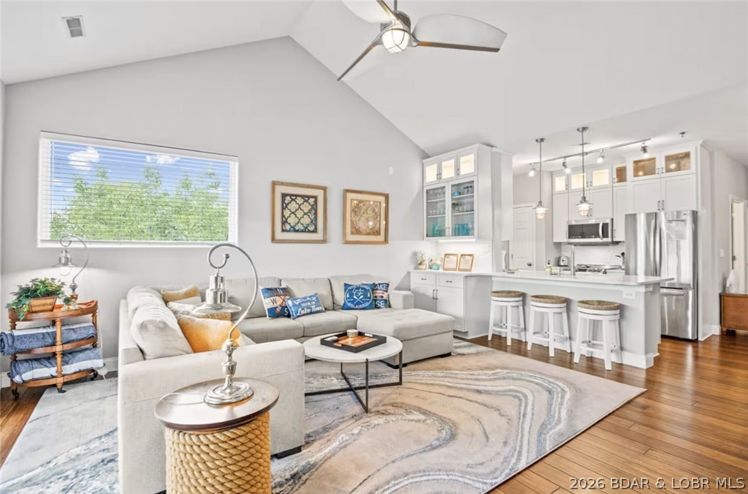 THIS ONE HAS IT ALL! Perched at the penthouse level, this beautifully remodeled 3BR, 1,500 sq ft luxury waterfront condo offers elevator access, a 40’ cruiser dock, and unobstructed panoramic lake views from one of the most desirable locations. This top-floor corner residence in a quiet cove showcases soaring ceilings, walls of glass, and exceptional natural light capturing both serene cove and main channel views. Rich hardwood floors flow throughout, leading to a refined kitchen with quartz countertops, shaker cabinetry, breakfast bar, and dining nook, all opening to an inviting great room with fireplace and generous seating. The primary suite is a true retreat with vaulted ceilings, breathtaking views, and a spa-inspired bath with jetted tub, separate shower, and dual vanities. A covered deck offers 240-degree views, BBQ, ceiling fan, and bar-height dining for effortless indoor-outdoor living. Offered turn-key furnished. Includes 40’ x 16’ dock with 2 PWC lifts, plus optional 32’ slip. New A/C and water heater. Enjoy a resort-style community with lakeside pool, ideally located near the dam, "The Strip", dining, shopping, and adjacent to Ozark Yacht Club for breakfast and lunch.
