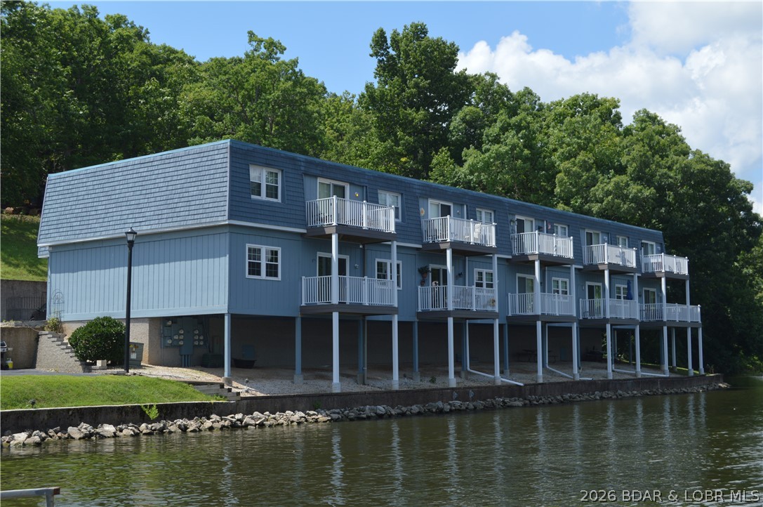 Rarely available walk-in Lake Forest condo! This 2 bedroom end unit has just been COMPLETELY refreshed including new LVP flooring, appliances, countertops, fixtures, paint, & refreshed cabinets and includes 10x28 boat slip. The HOA has recently replaced the exterior decking & roof making this condo affordable and highly desirable.  Lake Forest is a unique small condo development at the lake with lots of manicured green space and LOTS of amenities including clubhouse, 2 pools, rare covered fishing dock, & private boat ramp. The property has unobstructed lake views of Racetrack cove located at the 28 MM. This large cove is ideal for water sports or just relaxing while enjoying the cove protection. The property is conveniently located off Y road between Osage Beach & Camdenton--just minutes from shopping & restaurants by land or water. Don't miss this opportunity to enjoy lake life at an affordable price! Call your agent today.