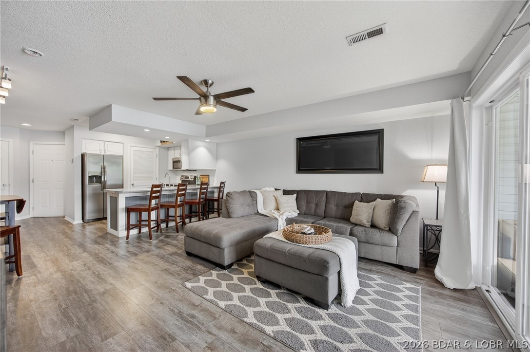 Wake up to calm cove water from your private screened deck — complete with bar seating, TV, and room to unwind. This turnkey 2BR/2BA condo at Lighthouse Landing is move-in ready with laminate flooring throughout, stainless appliances, a farmhouse sink, subway tile backsplash, and a stacked washer/dryer (new May 2024). The primary bath features a double vanity and custom tiled shower. Fresh HVAC (April 2023) and water heater (December 2024) mean the big-ticket items are done. 
On the water, your 12x32 dock slip (Dock 1, Slip 1-H) comes with a 10,000 lb. boat lift, dock locker, swim dock, and crappie beds steps away. Condo is located just 8 steps from parking. Extra storage with shelving and chest freezer accessible from outside the unit.
HOA covers internet, basic cable, sewer, water, trash, dock maintenance, grounds, and outdoor pest control and Heated/chilled pool on site. Located near all Lake Ozark amenities and entertainment!