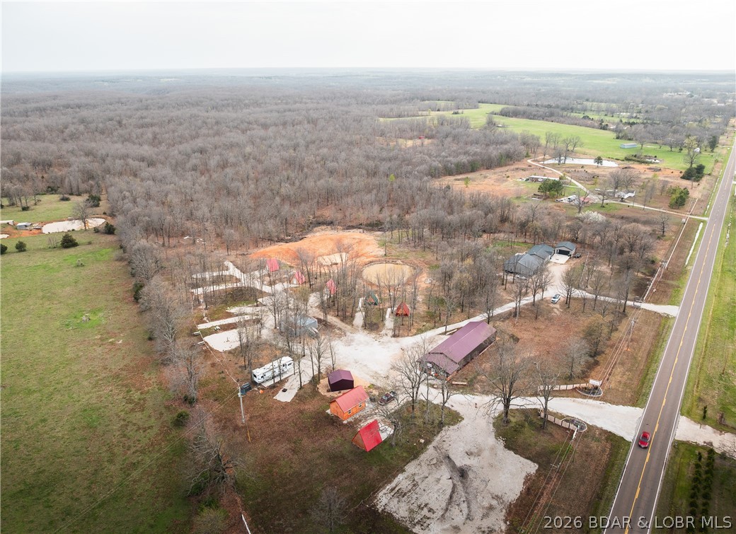Discover an incredible investment opportunity with this fully operational campground, perfectly situated on the highway near Bennett Springs Trout Park—a premier fishing and outdoor destination! Everything is nearly new and meticulously maintained, offering an effortless transition for new ownership. Lodging Options include 1 fully equipped cabin with kitchen & bath 6 A-frame camping cabins for a cozy retreat 2 RV sites with full hookups 7 RV sites with water & electric (30 & 50 amp) Scenic lake with a charming water feature 15 wooded acres with UTV/ATV trails for adventure seekers Store building for essentials & guest needs Shower house for camper convenience Workshop & machine shed for maintenance & storage Modern Residential Home Built in 2021 3 bedrooms, 2 baths Extra-high ceilings for an open, airy feel Fenced backyard & a beautiful patio Additional Storage & Workspaces include a 24x24 detached garage 40x40 insulated shop with concrete floors & full insulation.
