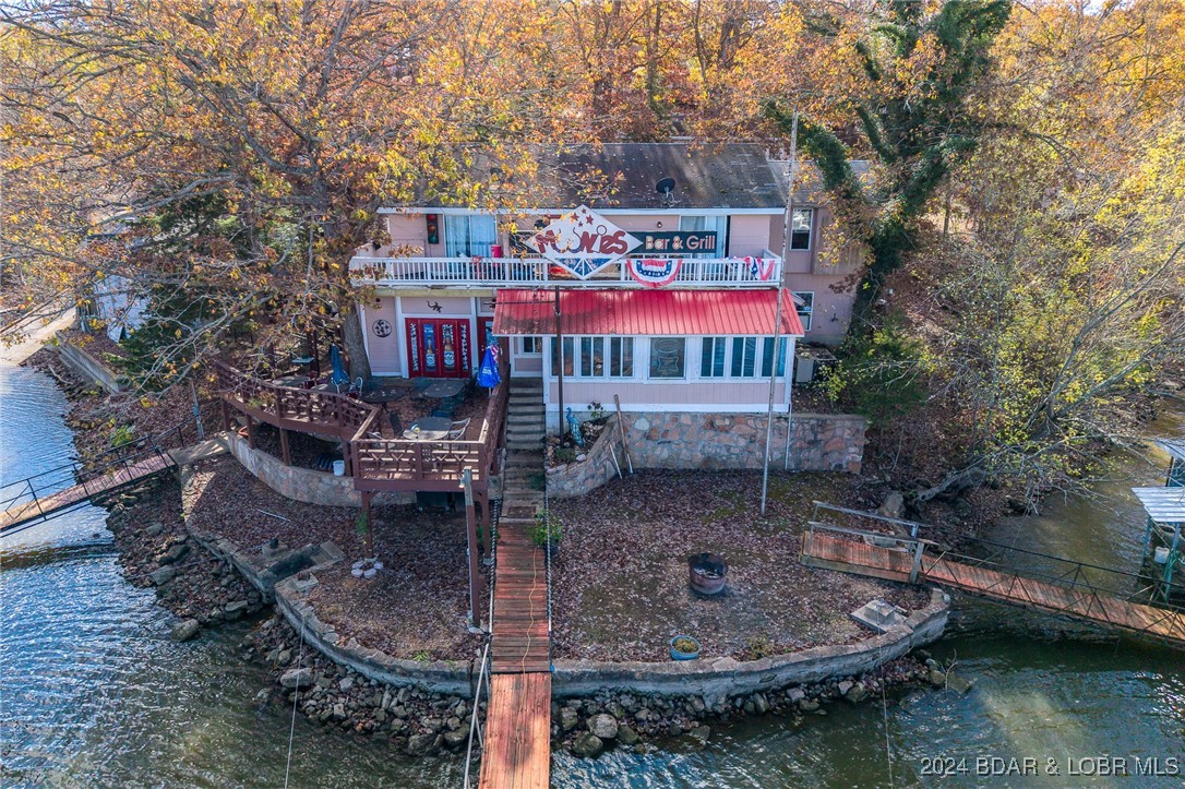Is it your dream to own your own business and a little piece of paradise at Lake of the Ozarks? Moonies Bar and resort has 700 feet of shoreline, 5 docks, 7 full time rented units, 5 rented RV spots and plenty of room in the 6 plex for the yearly fisherman or family vacationers.  The Septic system is up to Ameren code with new pumpstation and laterals. This quaint setting is perfect for full time living. THE BAR IS OPEN! fully staffed, Patrons galore.  Don't let this opportunity pass you by. Inspections are welcome for personal knowledge. The property is being sold AS-IS