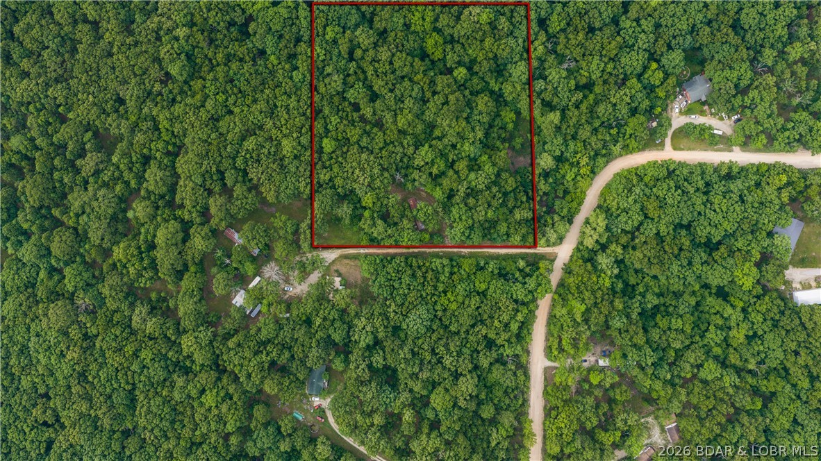 Discover the perfect blend of privacy and convenience with this beautiful 3.6-acre wooded property located between Osage Beach and Camdenton, just 2.6 miles off Hwy 54 down A Rd. A homesite is already established, with shared well, septic, and electric already in place—making it ready for your vision. Whether you’re looking to build your dream home, add a garage or ultimate man cave, or create the perfect Lake of the Ozarks getaway, this property offers endless potential. Enjoy the peaceful country setting while still being just minutes from shopping, dining, entertainment, and all the Lake Life activities you love. The existing mobile home is in rough condition and may need to be removed, but for the right buyer with a handy touch, there could be opportunity there as well. Rare combination of seclusion, utilities in place, and prime location—don’t miss this one!  Adjacent 3 acre lot  that includes a manufactured home is also available to purchase for a total of 6.62 acres.  See MLS 3587526 for more details.