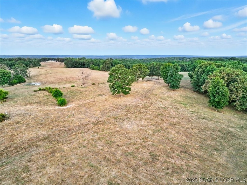 This rare 80+/- acre property offers the perfect blend of convenience and country living. 6 stock ponds plus a large catfish pond, 75% open Hay fields, fenced and crossed fenced, an old barn is included, Abundant wildlife with great stand locations throughout property. Located just outside city limits, yet close to town, opportunities like this are seldom available.  This is the first time on the market since the 1930s.  The land is fully equipped with excellent fencing and cross-fencing, multiple stocked ponds, and a couple of seasonal creeks, making it ideal for cattle, hay production, or recreation.  With a balance of open pasture and wooded acreage, the property provides outstanding hunting opportunities and is teeming with wildlife.  Whether you’re seeking productive farmland, recreational retreat, or a private homestead, this property checks all the boxes. All this with easy access, located 7 miles south of Camdenton.