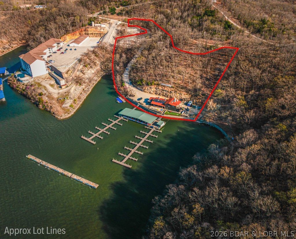 Back on the market at no fault of the sellers. It's your chance has arrived to own the LEGENDARY Larry’s on the Lake, one of the most recognizable, high-traffic lakefront destinations at the 31 MM of the Osage. Perfectly positioned on 5 sprawling acres with an impressive 500 feet of gentle shoreline, this property offers unmatched visibility, easy access by land and water, and endless possibilities for future development. At the center of it all is the iconic, grandfathered floating tiki bar—a one-of-a-kind attraction that simply can’t be duplicated. This massive floating structure features multiple dining areas, a full stage for live music, and a spacious dance floor that keeps the energy going all summer long. The oversized dock allows diners to sit just inches above the water, providing unbeatable ambiance for boaters and families alike. With 5 acres of usable ground, this is a developer’s dream—imagine adding luxury condos, an upper-level wedding and event venue, a boutique marina, resort-style swimming pool, or even a full RV park. The topography, location, and shoreline make this one of the most versatile commercial sites on the lake.