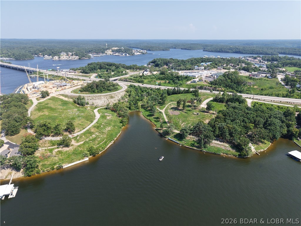 Exclusive Lake Ozarks Waterfront Development Opportunity!! Experience one of the last great pieces of prime shoreline real estate on Lake of the Ozarks. Spanning 6.5 +/- acres with additional 8 that can be purchased also.  Pristine waterfront, this property offers endless potential for a luxury resort, marina, or private estate enclave. Situated along prestigious Jeffries Street, these commercial and waterfront lots combine elite accessibility with breathtaking panoramic views. Property highlights are gently sloping terrain ideal for luxury builds, exceptional water frontage and sunset exposure and rare large-acre offering in the heart of Lake of the Ozarks. All utilities nearby and easy highway access.
