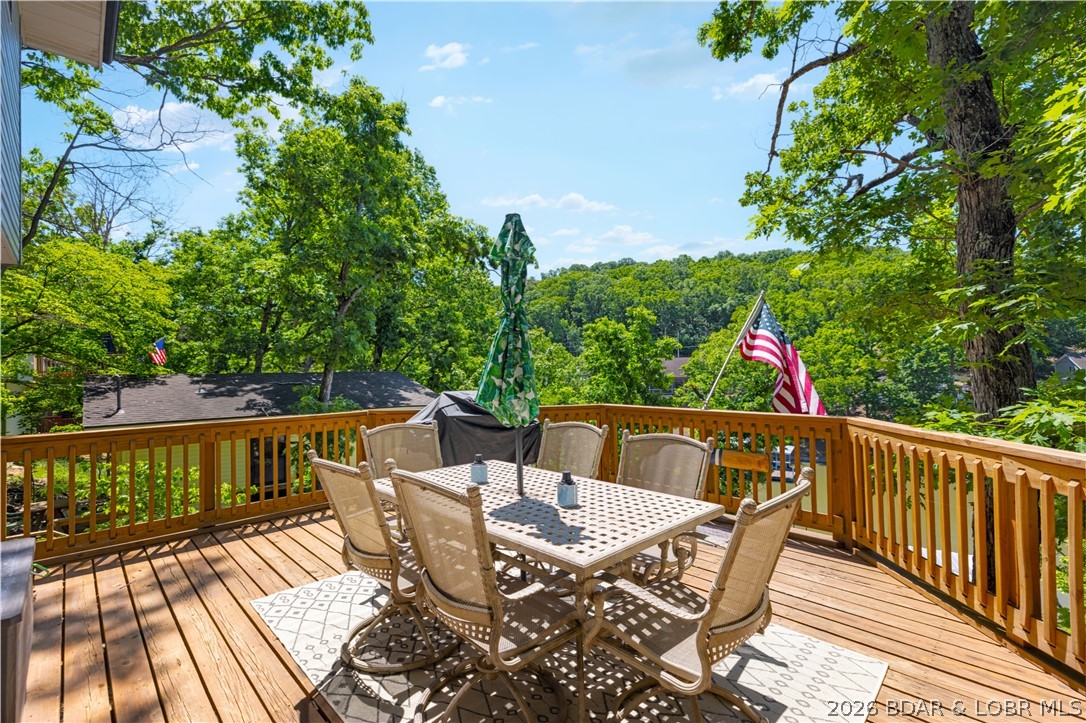 Tucked along a quiet cove at the 3 MM, 131 Walnut Drive is the kind of Lake Ozark retreat that feels easy from the moment you arrive. Fully remodeled and furnished, this lakefront getaway offers updated finishes, a newer roof, newer septic, newer front porch, newer deck, and newer steps leading down to the dock. Spend mornings with coffee on the deck, afternoons on the water from your covered 1-well dock with 10x26 slip, and evenings relaxing in a move-in-ready space designed for lake life. With vacation rentals allowed, 50 feet of waterfront, a surveyed lot, and a walkout lower level, this property offers both personal enjoyment and income potential. The 3rd bedroom is non-conforming with no closet.