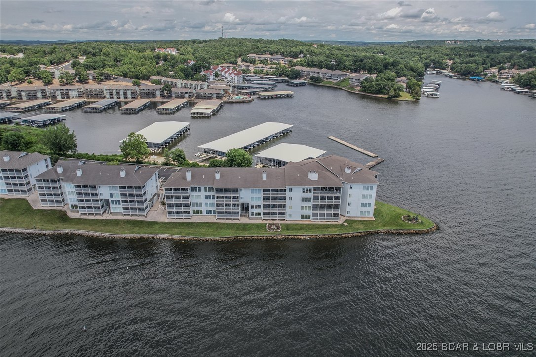 Fantastic condo at Regatta Bay! Clean, Clean, Clean and Pristine!  Super views and in the building right before the point building, too! 2 bedroom 2 bathroom fully-furnished lower end condo is perfect for walking right out onto the point.  Great for pets and access to lakefront. Views are wonderful from the screened in deck to watch boats and water activities. 12'x32' boat slip right across the parking lot on Dock 11 Slip 15 L with a Midwest touchless boat cover and dock box. Storage unit right outside for all your personal boat toys and swim gear! 2 community pools (one on the waterfront and the other up by the clubhouse, picnic pavilion, tennis courts, pickleball and a new playground for the kiddos!! So many amenities on 13 acres and park-like setting. Great walking, too. Desirable and convenient location by land and water close to all the waterfront restaurants, close to town, the Famous Bagnell Dam strip, theater, grocery stores, and Osage Beach for more shopping. Great value all around! Schedule your tour today!