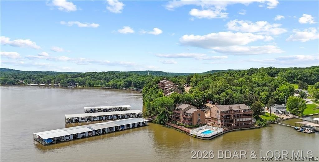 ONE OF THE LARGEST ONE BEDROOM CONDOS CURRENTLY ON THE MARKET! This walk-in unit offers minimal concrete steps into your unit with direct access to the lakefront pool and lakefront boardwalk & docks! Welcome to Lake Valley Condominiums located at the 13 mile marker of the Big Niangua at Lake of the Ozarks. This oversized one bedroom/one bathroom lakefront condo comes turn-key, offers over 800sq ft of open concept living space and also comes with a 10x20 boat slip, dock locker and a 4,500lb boat lift. You will love the direct access from your front door and private screened-in patio to the outdoor pool and lakefront boardwalk. This unit offers a stone wood-burning fireplace, granite countertops and LG stainless appliances. The Big Niangua is known for great fishing-so you will certainly enjoy having access to the fish cleaning station on the community dock. Come take a peek for yourself and fall in love with this peaceful complex on quiet waters! With only about 42 units total, the complex offers a serene environment. USPS private mailbox is included at no additional charge at the complex!
