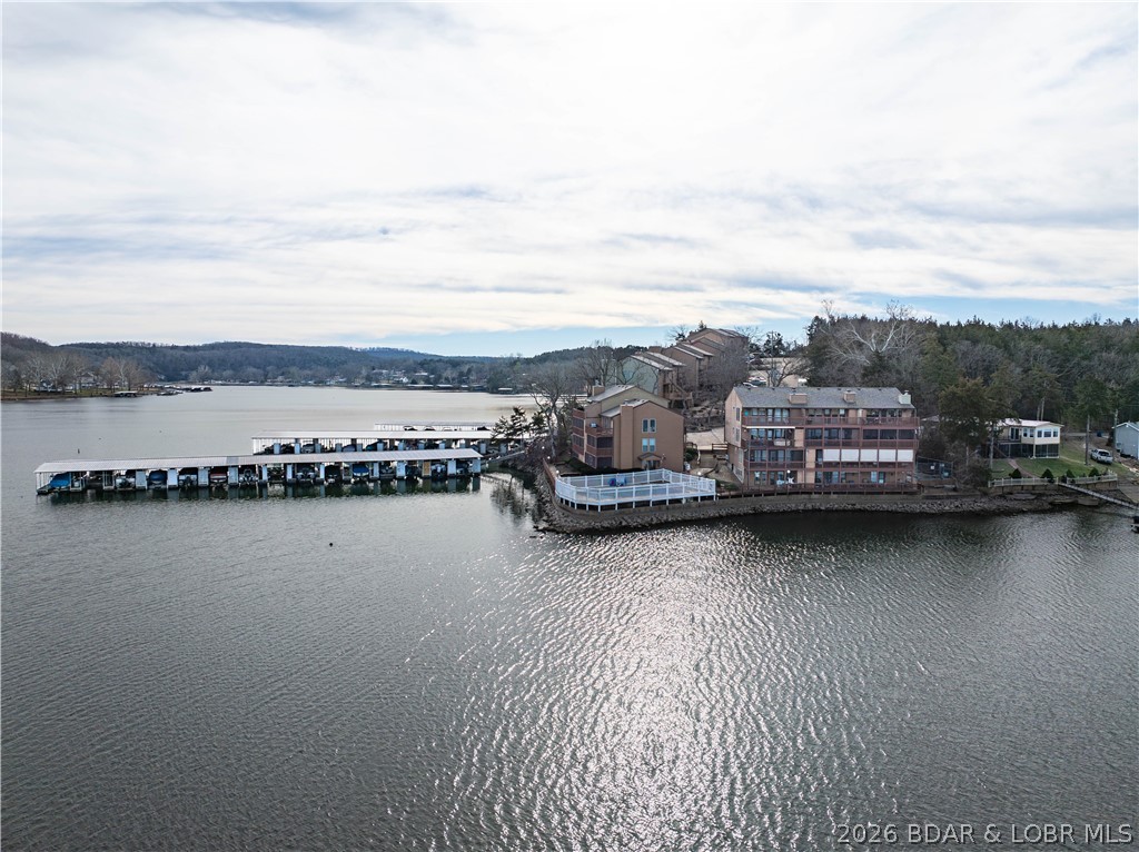 ONE OF THE LARGEST ONE BEDROOM CONDOS CURRENTLY ON THE MARKET! This walk-in unit offers minimal concrete steps into your unit with direct access to the lakefront pool and lakefront boardwalk & docks! Welcome to Lake Valley Condominiums located at the 13 mile marker of the Big Niangua at Lake of the Ozarks. This oversized one bedroom/one bathroom lakefront condo comes turn-key, offers over 800sq ft of open concept living space and also comes with a 10x20 boat slip, dock locker and a 4,500lb boat lift. You will love the direct access from your front door and private screened-in patio to the outdoor pool and lakefront boardwalk. This unit offers a stone wood-burning fireplace, granite countertops and LG stainless appliances. The Big Niangua is known for great fishing-so you will certainly enjoy having access to the fish cleaning station on the community dock. Come take a peek for yourself and fall in love with this peaceful complex on quiet waters! With only about 42 units total, the complex offers a serene environment. USPS private mailbox is included at no additional charge at the complex!