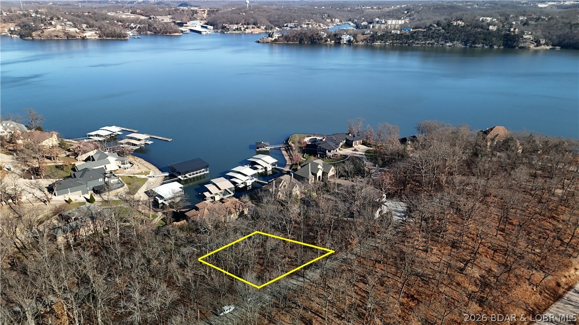 Welcome to Porto Cima-where panoramic lake views meet refined living at Lake of the Ozarks. This premier homesite offers sweeping, unobstructed view of the water, surrounded by luxury homes in one of Missouri's most exclusive lake communities.

Design and build the home you've always envisioned, taking full advantage of the lot's dramatic elevation and lake-facing orientation. A professional survey is complete, and architectural plans for a striking two-story walkout home with swimming pool are available offering a head start on turning this vision into reality.

Life in Porto Cima is defined by resort-style amenities: multiple outdoor and indoor pools, pickleball courts, a community center, and convenient boat ramps, plus nearby community boat slip for effortless lake access.

Residents also enjoy optional access to The Club at Porto Cima, featuring a private Jack Nicklaus Signature golf course with practice facilities, a golf clubhouse, members pool complex, fitness center, and Yacht Club Marina boat slips. 

This is more than a homesite-it's an invitation to a lifestyle of luxury, leisure, and lake living at its finest.