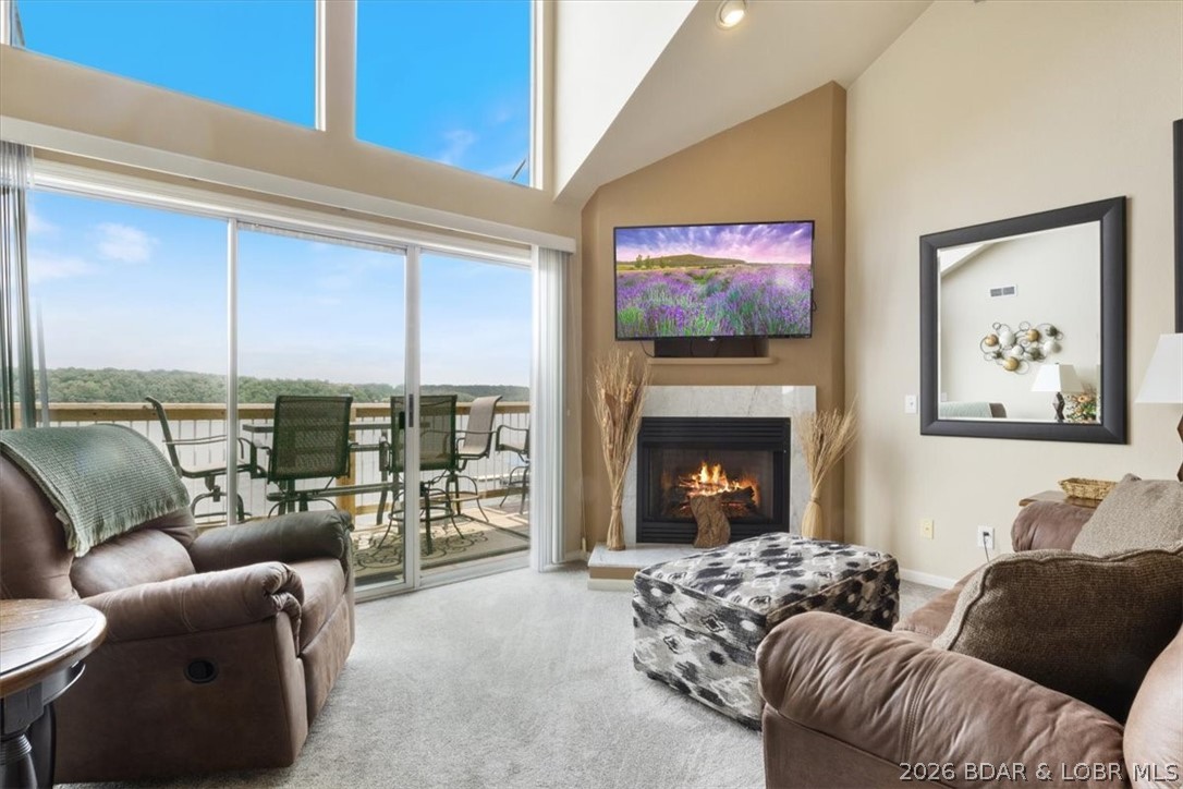 This beautifully updated condo sits high above the lake with soaring ceilings and an entire wall of windows that frame miles of open water. Morning coffee on the deck? Sunset cocktails? It all feels like you’re on vacation—because here, you kind of are. Located in the heart of Osage Beach at the 21MM, you’re minutes from the lake’s best restaurants, shopping, and entertainment. Your boat stays protected in a calm cove with a breakwater, so you can watch the go-fast boats cruise by without the waves rocking yours. Looking for an investment property? This unit is completely turn-key—furnished, styled, and fully stocked giving you a seamless, income-producing start from day one. The Ledges offers two pools, a sandy beach, and a playground — making it a favorite for families and vacationers alike. And the spacious loft functions as a generous third bedroom, giving you plenty of room for guests.