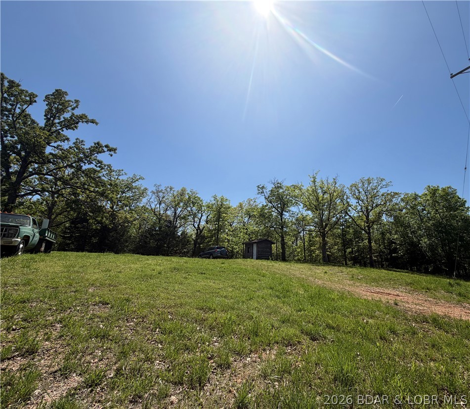 Discover the perfect spot to build your Lake of the Ozarks dream. This larger-than-average Osage Beach parcel offers a seasonal lake view, lake easement, gentle terrain, and the kind of space and flexibility that’s hard to find in town. Tucked in a quiet setting yet minutes from shopping, dining, medical services, and the exciting new Bass Pro development, it blends convenience with a peaceful, retreat-like feel. Whether you’re planning a full-time residence, a seasonal getaway, or an investment property designed for long-term value, this lot gives you room to design exactly what you want—outdoor living, extra parking, a shop, or future expansion. Public utilities are available that adds to the ease of building. A rare opportunity in a fast-growing corridor of Osage Beach—secure your piece of the lake lifestyle and create a property that fits your vision.