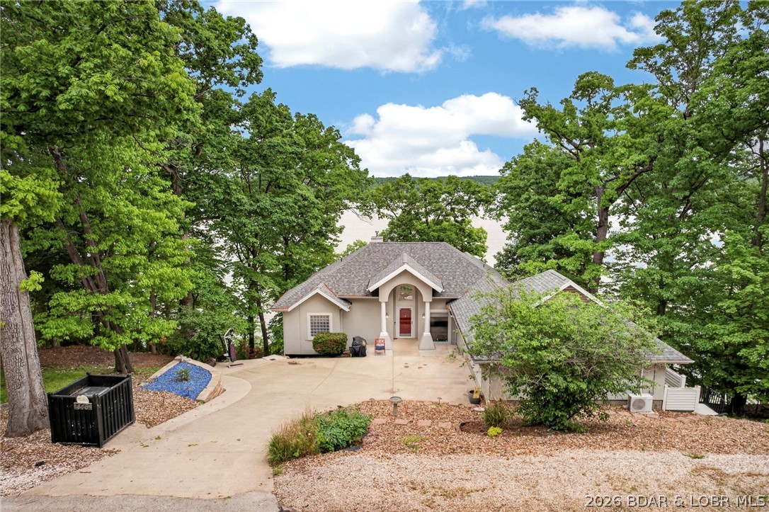 Set within one of the most sought-after neighborhoods in Four Seasons, this exceptional lakefront retreat offers timeless design, thoughtful updates & an unmatched connection to the water. Ideally located near the Swim & Tennis Club, the home was built in 2002 and blends classic architecture with modern comfort. Recent upgrades provide peace of mind, including a 50-year transferable warranty roof installed in 2021, newer HVAC, RO System, a mini-split system in the garage, & updated appliances throughout. Inside, the home is designed for both everyday living and effortless entertaining. Step outside to take in the spectacular main channel views from the screened deck, where you can relax surrounded by nature and watch wildlife in a serene, private setting. With 118 feet of stunning lakefront, the property offers a generous dock envelope—ready for you to create the ultimate waterfront setup tailored to your lifestyle. Unwind to the soothing sound of waves against the natural seawall, or enjoy time with family and friends in the game area, complete with a pool table included in the sale. This is more than a home—it’s a lakefront experience defined by beauty, comfort, and possibility.