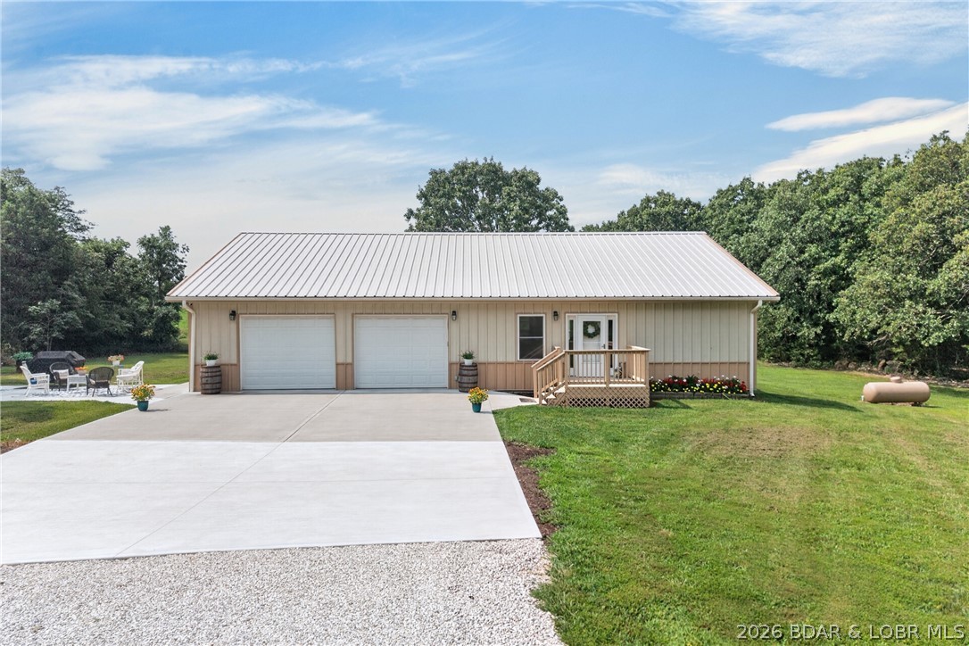 The perfect combination of newer construction, low-maintenance living, and usable acreage! Built just 3 years ago, this move-in-ready home sits on 3 beautifully level acres between Camdenton and Macks Creek. Although it has a Macks Creek address, it’s located in the desirable Camdenton School District. Designed for easy ownership, the home features durable all-metal siding and a metal roof. Inside offers 1,632 sq. ft. with 2 bedrooms, 2 full baths, luxury vinyl plank flooring throughout the main living areas, and an open-concept floor plan. The kitchen boasts custom cabinetry, granite countertops, stainless steel appliances, plus a granite-topped serving bar with a second refrigerator. The spacious primary suite features a private bath with a full-width walk-in shower. A heated and cooled 32x24 attached garage provides plenty of room for vehicles, hobbies, or storage, with additional attic storage above. Relax on the back deck or poured patio while enjoying the peaceful country setting. A rare opportunity to own a nearly new home with level topography, minimal maintenance, and room to spread out—just minutes from both Camdenton and Macks Creek! This one check all the boxes!