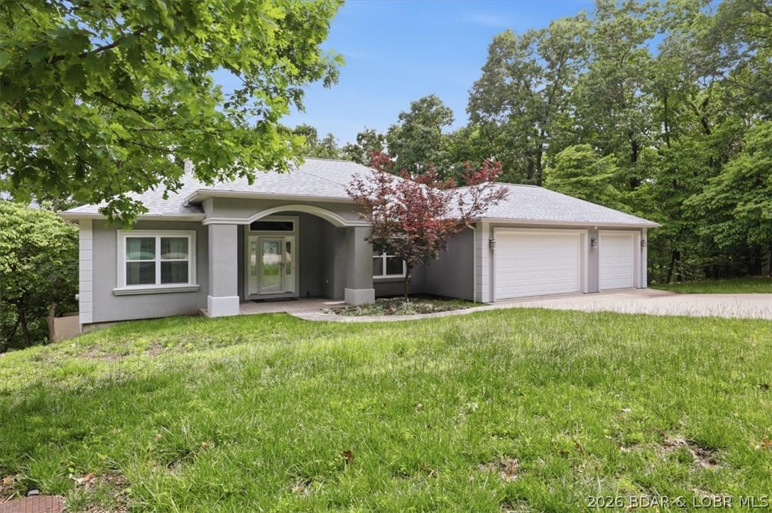 Fantastic lakeview with this spacious 5-bedroom, 3-bath home in the highly desirable Four Seasons Lake Ozark community. With over 2,700 sq ft on more than 1/3 acre, this property offers year-round lake views and a private, nature-filled backdrop as it borders a peaceful greenbelt. The main level provides true one-level living with separate dining room, breakfast area, large living room w/fireplace & vaulted ceiling, 3 bedrooms and 2 bathrooms, including a primary suite featuring a large tiled walk-in shower and generous walk-in closet. The open layout flows to a covered deck with a view of the lake—perfect for morning coffee or evening relaxation. The finished walkout basement adds a family room, two additional bedrooms, a full bath, and ample storage. A 3-car garage with shelving and toolboxes offers exceptional workspace and organization. Major updates include a new roof (2024), new HVAC (2024), new dishwasher (2024), and brand new Maytag washer & dryer. Enjoy Four Seasons amenities plus nearby walking and biking paths, parks, pools, and tennis courts. A rare blend of space, views, updates, and location in the heart of Lake Ozark living.
