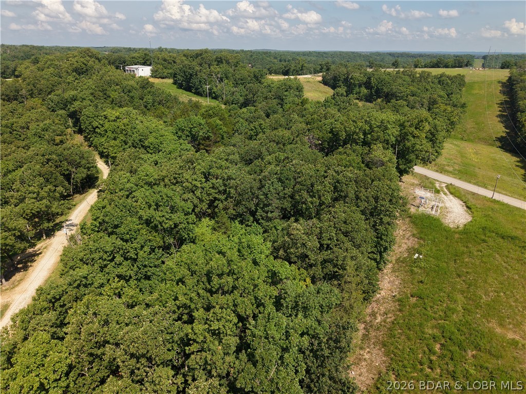 Build your future on this 5.4-acre wooded tract located off Red Dirt Road in the Twin Rivers Point area near Greenview. With gently rolling terrain and mature timber, this property offers the opportunity to create a setting that fits your goals, whether you're planning a full-time residence, weekend getaway, recreational basecamp, or long-term investment. The natural landscape provides a blank canvas while still offering the convenience of nearby Lake of the Ozarks attractions, marinas, restaurants, and outdoor recreation. Owners enjoy shared community lake access, making it easy to spend time on the water without the premium of waterfront ownership. If you've been searching for acreage that offers flexibility, affordability, and room to bring your ideas to life, this property deserves a closer look. Seller prefers seller financing terms, creating an excellent opportunity for buyers seeking flexible financing options